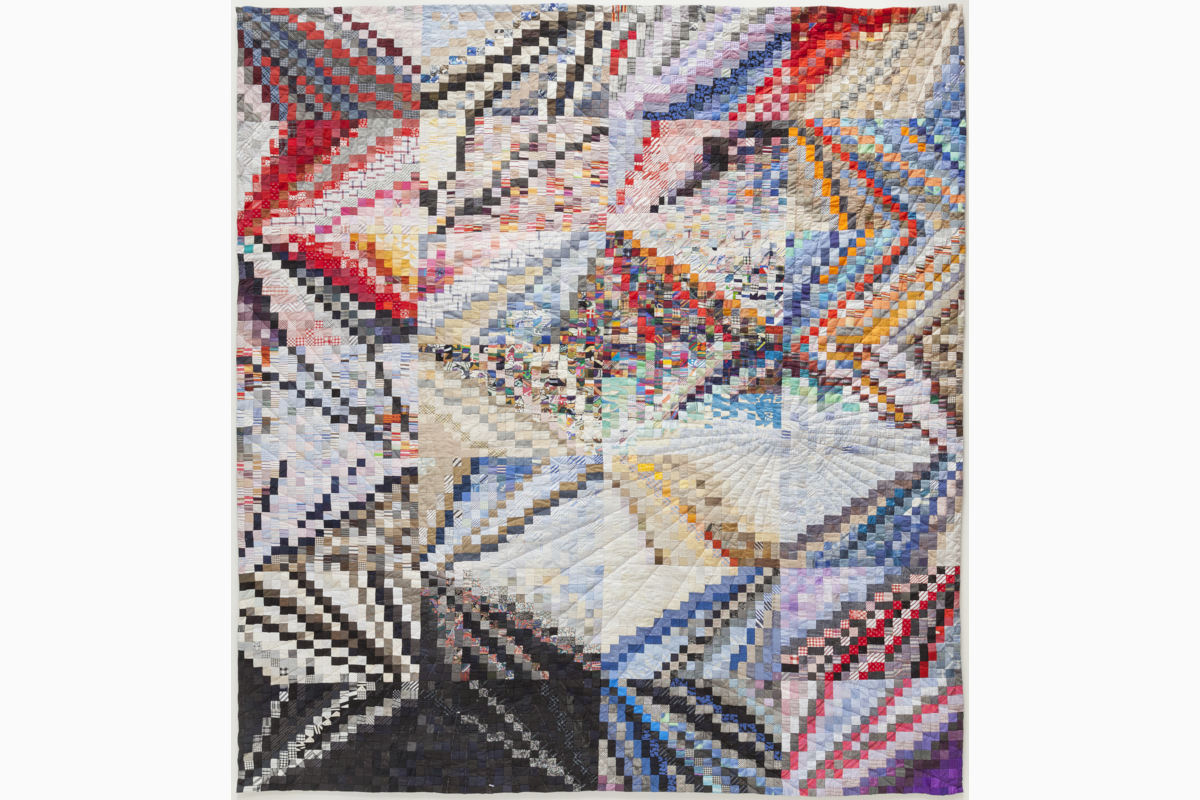 Sabine Cibert Instants 2 ©Philippe-Liev Pourcelot Colorful geometric quilt with overlapping chevron motifs in a patchwork of triangles and diamonds; wall hanging. (informative)