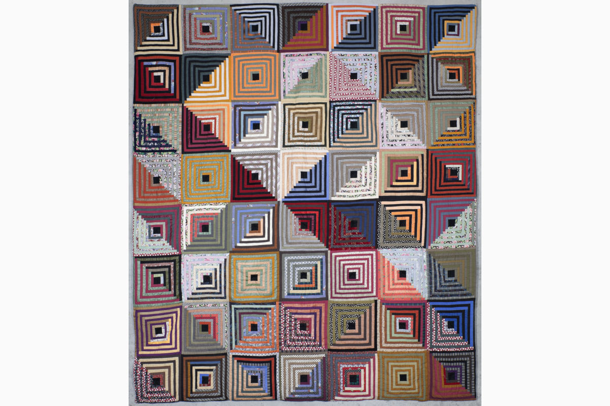 Sabine Cibert Log Cabin Light Show ©Philippe-Liev Pourcelot Quilted textile with an 8-by-8 grid of blocks, each block showing nested concentric squares in bright, varied colors.