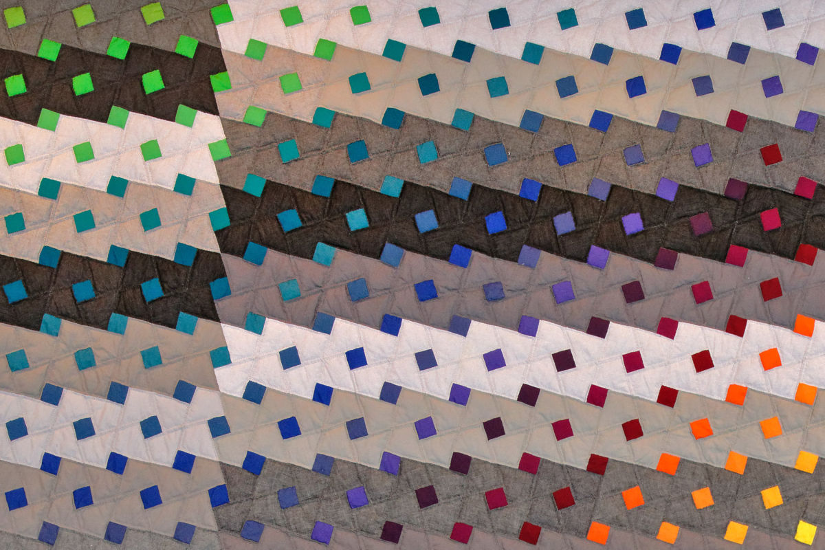 Sabine Cibert - Pluie de couleur 2 - détail ©Pascal Muradian Abstract quilt with diagonal bands of small colored squares in greens, blues, purples, and reds.