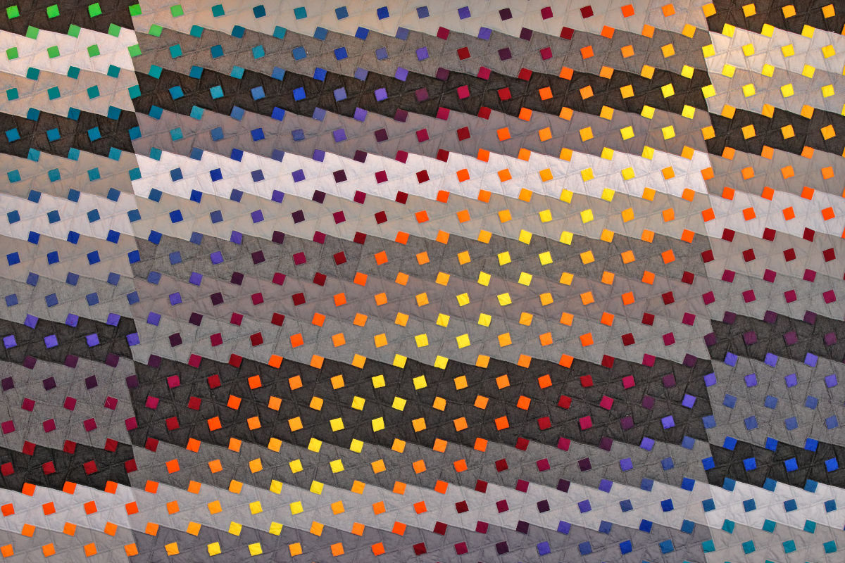 Abstract geometric artwork with diagonal bands of tiny colored squares in rainbow hues and muted grays, creating a textured, layered pattern.